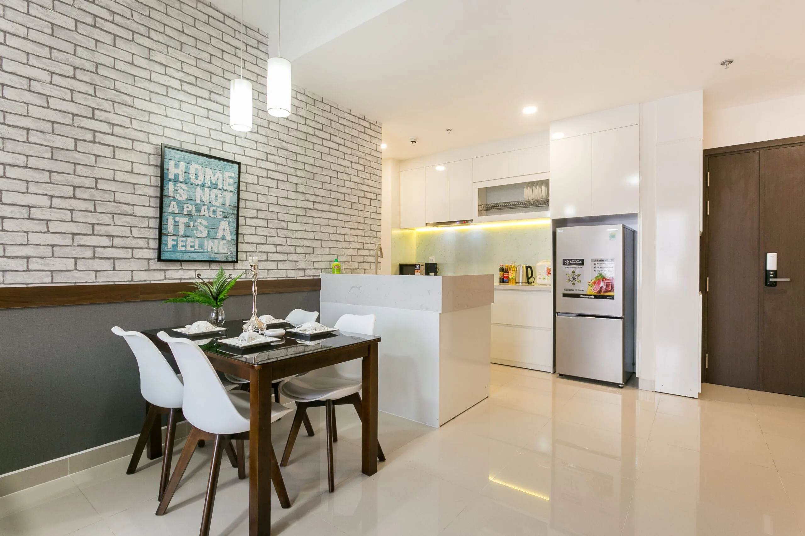Dining and kitchen area in Two-Bedroom Apartment at RiverGate Residence
