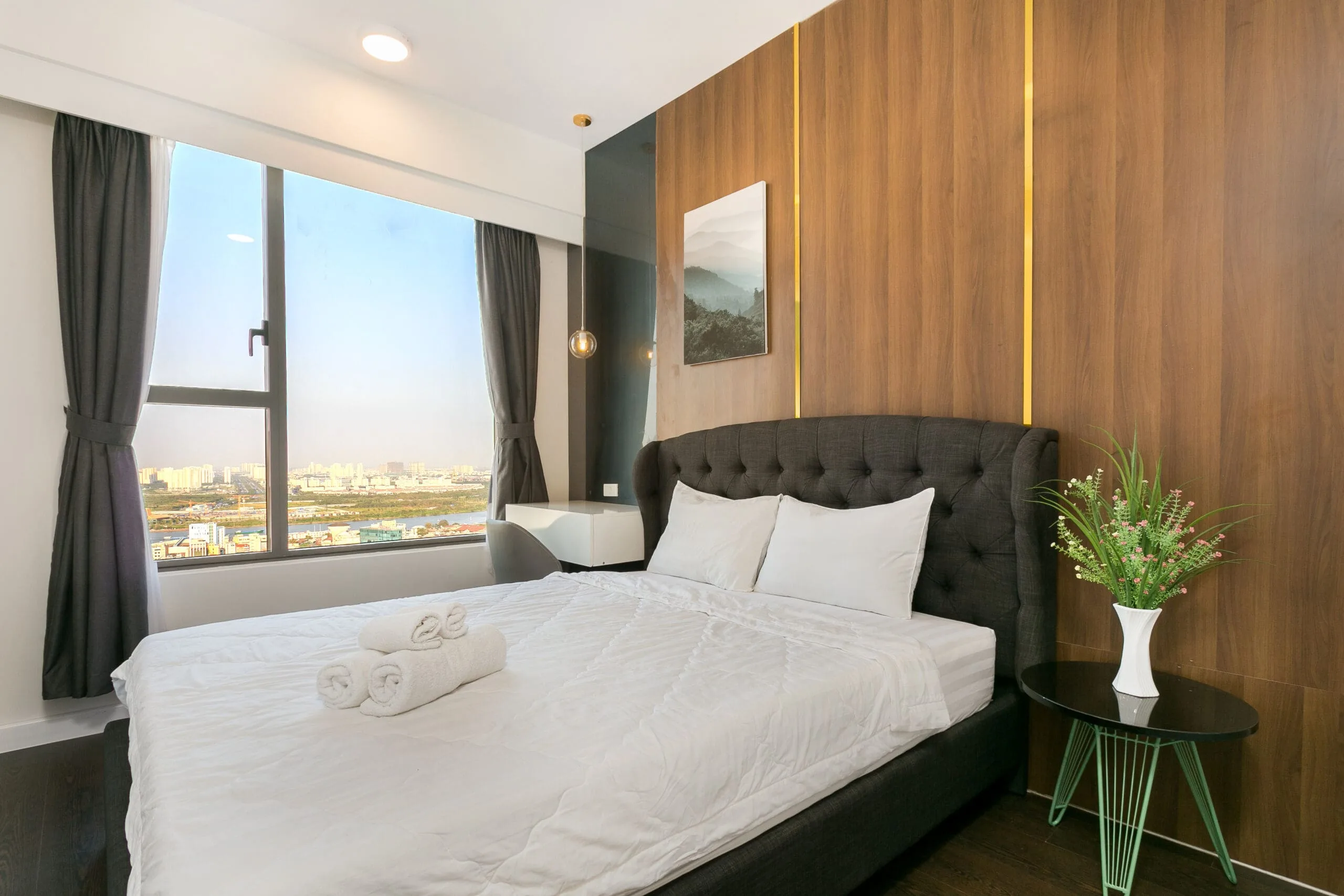 Master bedroom with city view in Two-Bedroom Apartment at RiverGate Residence