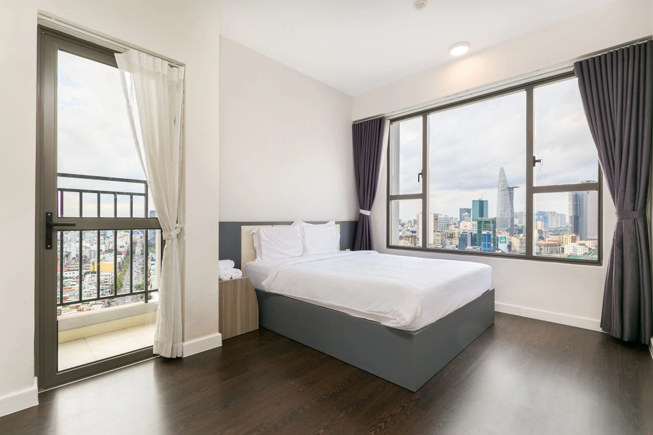 Master bedroom with balcony in Three-Bedroom Apartment at RiverGate Residence
