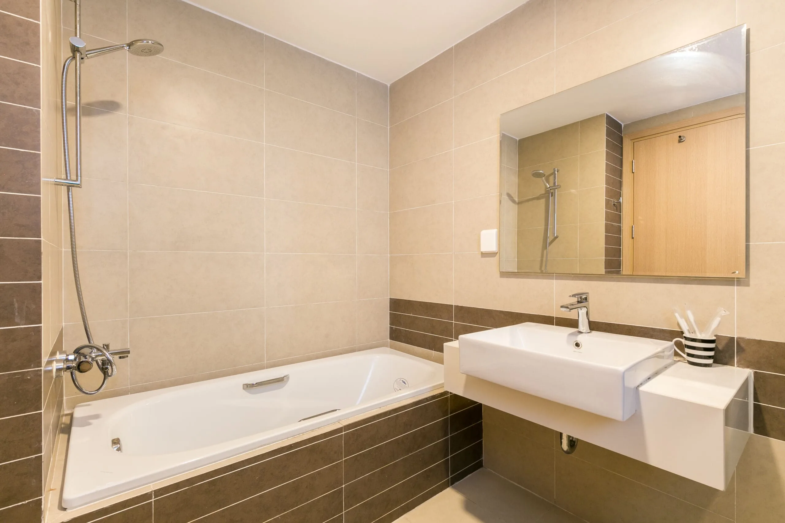Master bathroom with bathtub in Three-Bedroom Apartment at RiverGate Residence