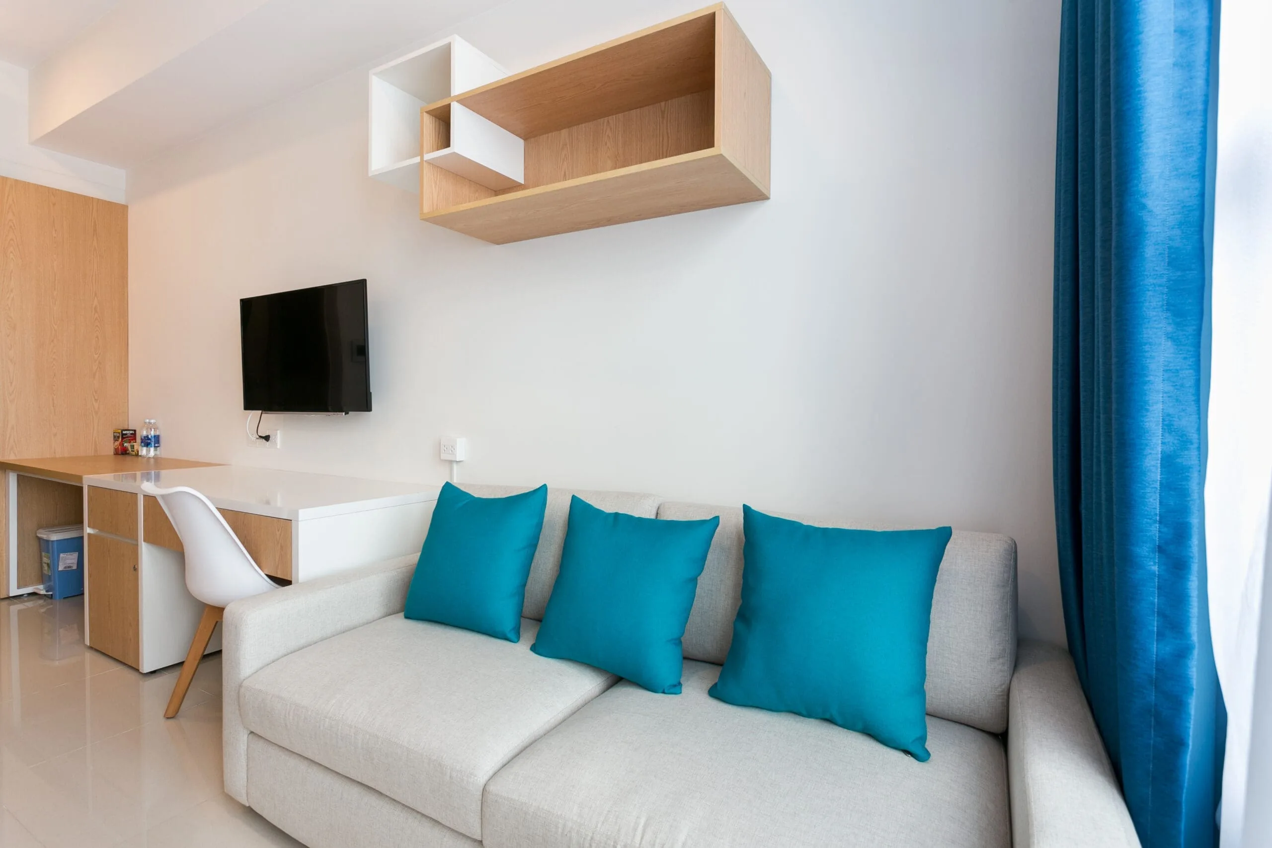 Sofa and workspace in Studio Apartment at RiverGate Residence