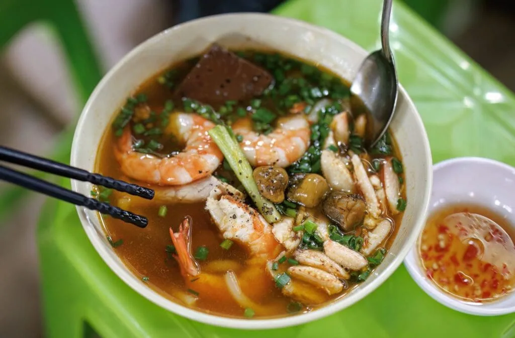 Vietnamese thick noodle soup with crab (Bánh Canh Cua) served hot at Ben Thanh Market in Ho Chi Minh City.