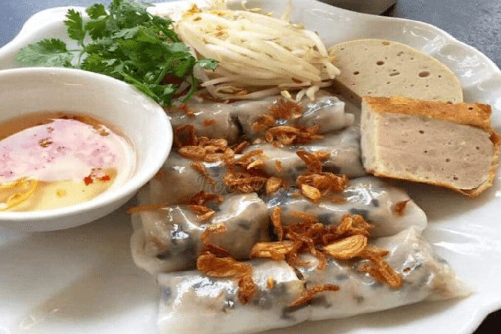 Vietnamese steamed rice rolls (Bánh Cuốn) filled with minced pork and mushrooms, served at Ben Thanh Market in Ho Chi Minh City.