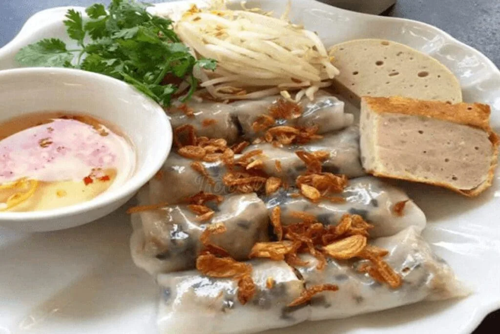 Vietnamese steamed rice rolls (Bánh Cuốn) filled with minced pork and mushrooms, served at Ben Thanh Market in Ho Chi Minh City.