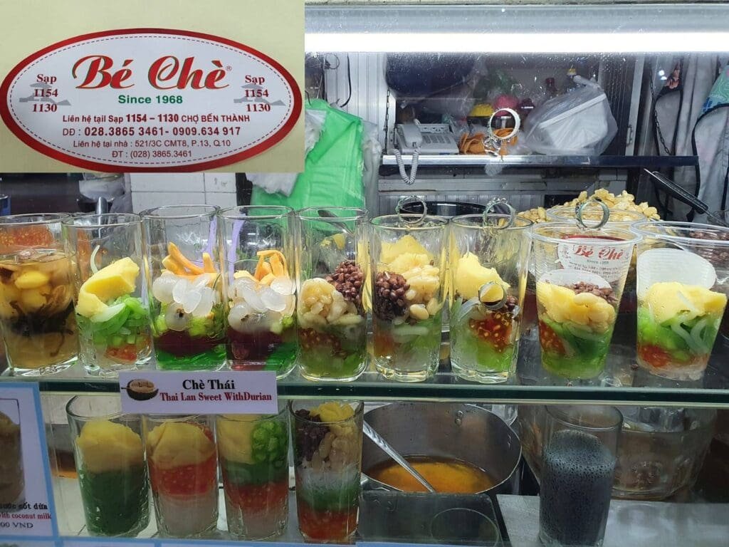 Traditional Vietnamese sweet dessert (Chè) served in colorful varieties at Ben Thanh Market in Ho Chi Minh City.