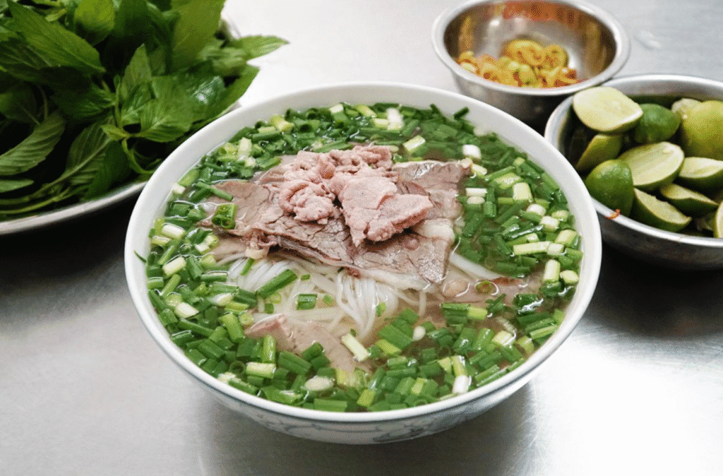 Traditional Vietnamese beef noodle soup (Phở Bò) served at Ben Thanh Market in Ho Chi Minh City.