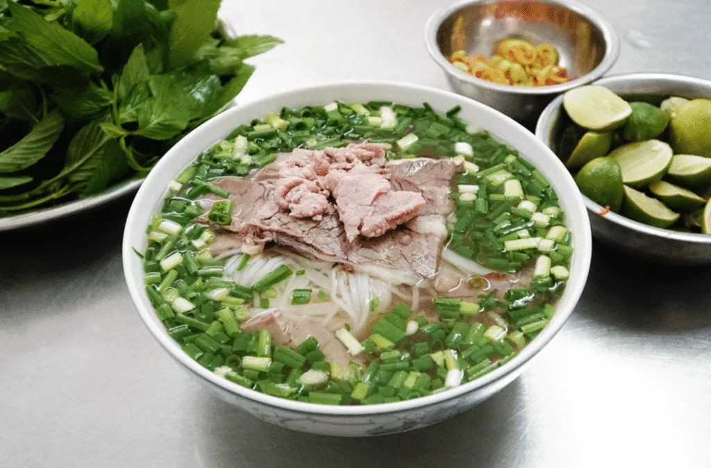 Traditional Vietnamese beef noodle soup (Phở Bò) served at Ben Thanh Market in Ho Chi Minh City.