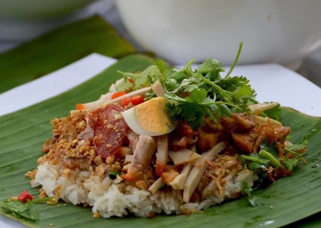 Vietnamese mixed sticky rice (Xôi Thập Cẩm) with Chinese sausage, shredded chicken, and dried shrimp, served at Ben Thanh Market in Ho Chi Minh City.