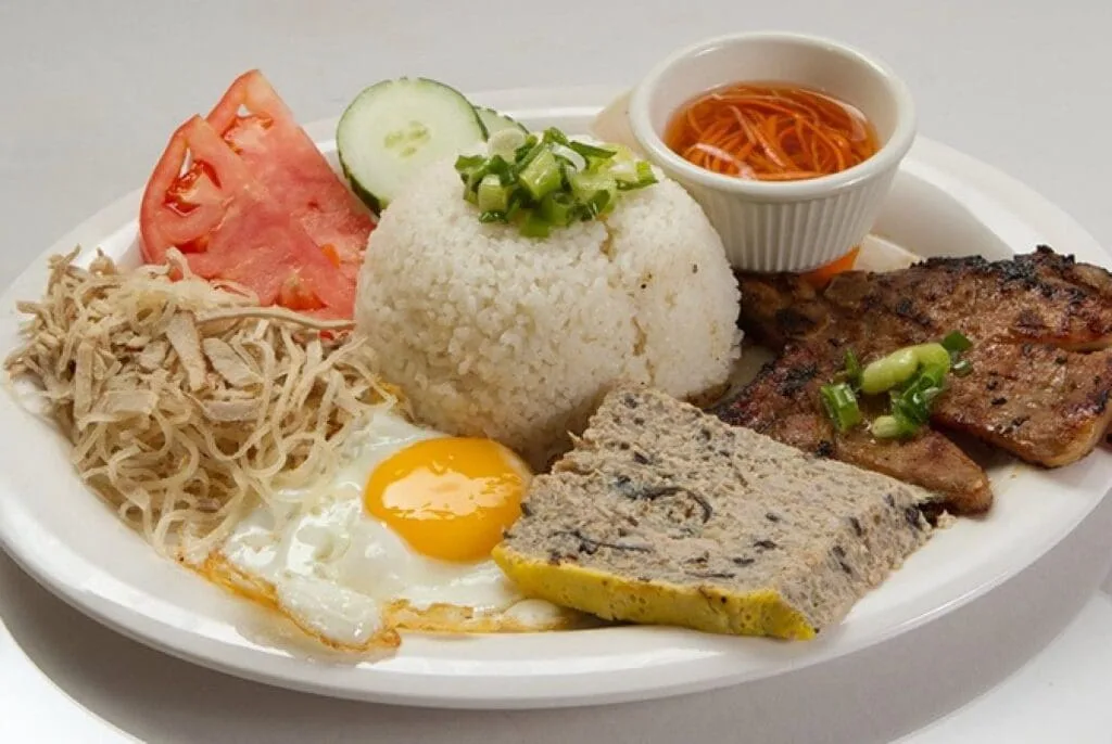 Vietnamese broken rice dish (Cơm Tấm) with grilled pork, served at Ben Thanh Market in Ho Chi Minh City.