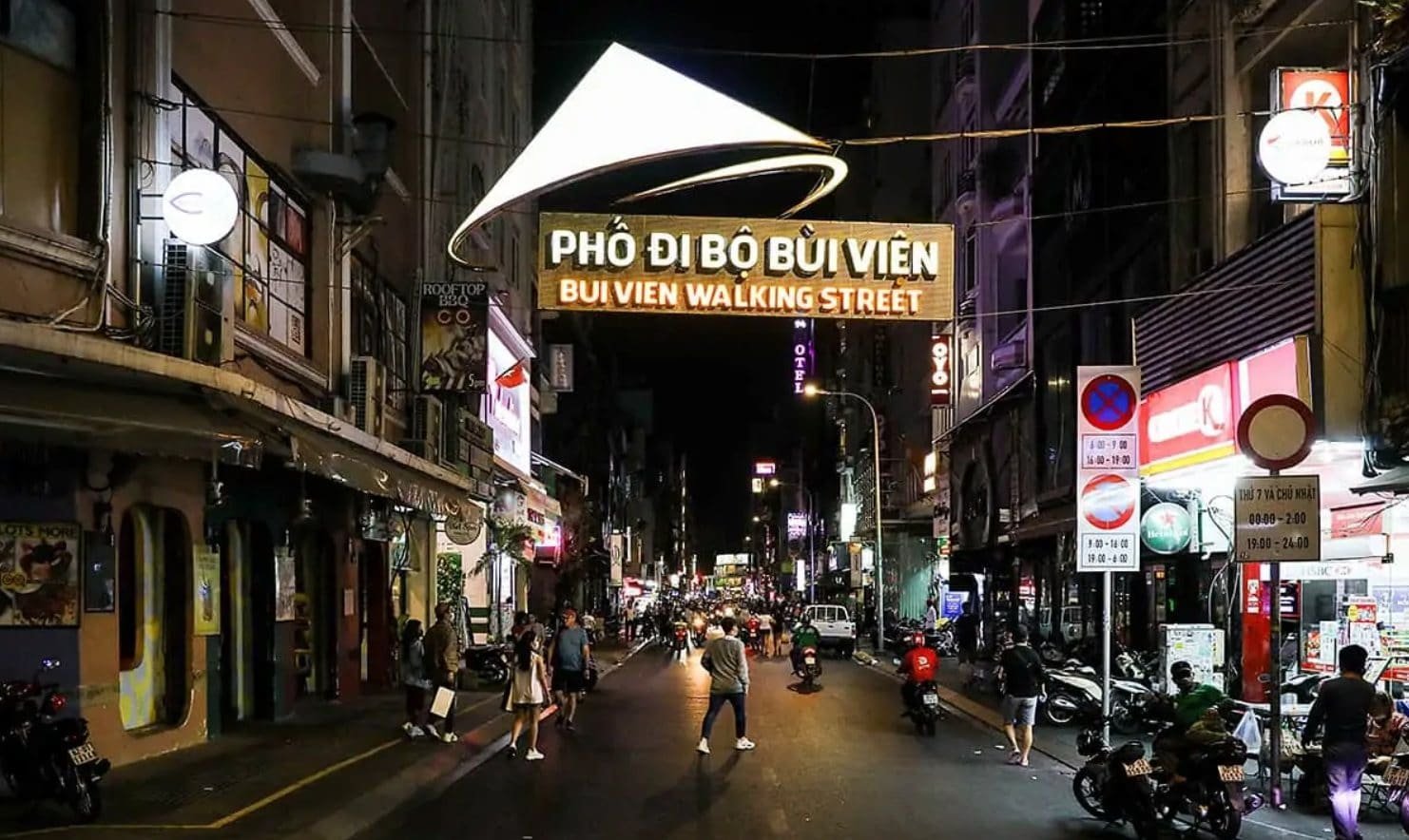 Vibrant night scene at Bui Vien Walking Street in Ho Chi Minh City, with colorful lights, street food stalls, and crowds enjoying Saigon nightlife.
