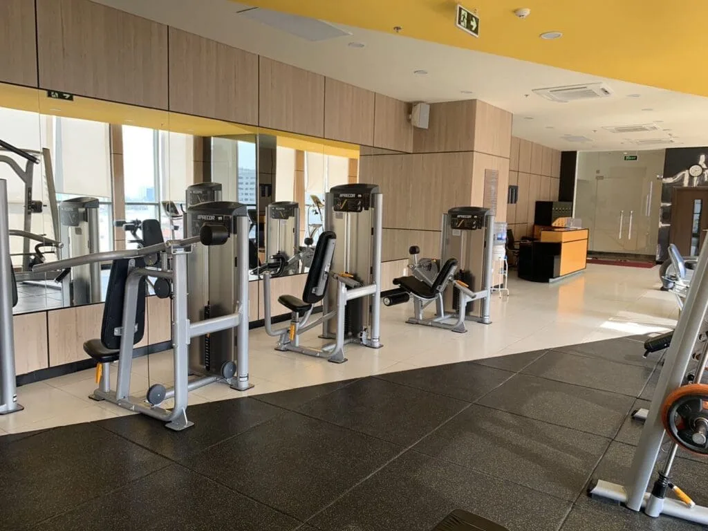 Modern gym with cardio machines and weight training equipment at RiverGate Residence Saigon